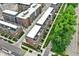 Aerial view of newly built complex showing rooftops, walkways, and surrounding tree lined streets at 906 Berkhamsted Ln, Carmel, IN 46032