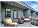 Stylish outdoor balcony featuring wicker furniture, perfect for relaxing and entertaining at 906 Berkhamsted Ln, Carmel, IN 46032
