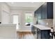 Bar area with dark wood cabinets, light countertops, stainless steel appliances, and a view of the balcony at 906 Berkhamsted Ln, Carmel, IN 46032