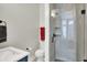 Bathroom featuring a shower with glass doors, tile floors, and a blue vanity at 906 Berkhamsted Ln, Carmel, IN 46032