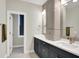 Elegant bathroom with double sinks, quartz countertops, gray cabinets, and modern vanity lights at 906 Berkhamsted Ln, Carmel, IN 46032
