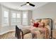 Bedroom featuring a metal bedframe, hardwood floors, and natural light from the windows at 906 Berkhamsted Ln, Carmel, IN 46032
