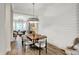 Elegant dining room with modern lighting, wood floors, and a stylish table setting at 906 Berkhamsted Ln, Carmel, IN 46032