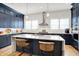 Beautiful kitchen featuring blue cabinets, quartz countertops, modern island and stainless appliances at 906 Berkhamsted Ln, Carmel, IN 46032