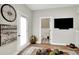 Comfortable living room with modern decor, bright natural light, hardwood floors and easy powder room access at 906 Berkhamsted Ln, Carmel, IN 46032