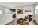 Living room featuring a bar area, hardwood floors, neutral paint, and a leather chair at 906 Berkhamsted Ln, Carmel, IN 46032