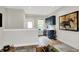 Living room featuring a bar area, hardwood floors, neutral paint, and a painting at 906 Berkhamsted Ln, Carmel, IN 46032