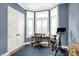 Home office with hardwood floors, large window, plantation shutters, and neutral paint at 906 Berkhamsted Ln, Carmel, IN 46032