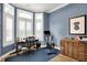 Bright office area with hardwood floors, a desk, a peloton, and natural light from the large windows at 906 Berkhamsted Ln, Carmel, IN 46032