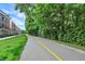Curving walking path next to new townhomes and lush green trees at 906 Berkhamsted Ln, Carmel, IN 46032