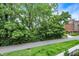 View of a walking path with trees, foliage, and a building in the distance at 906 Berkhamsted Ln, Carmel, IN 46032