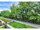 A scenic view of a walking path lined with lush trees and manicured landscaping at 906 Berkhamsted Ln, Carmel, IN 46032