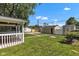 Wide backyard featuring two sheds, green grass, and pathway at 917 W Busby St, Lebanon, IN 46052
