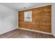 Cozy bedroom featuring wood accent wall, natural light, and neutral wall paint to customize your space at 917 W Busby St, Lebanon, IN 46052