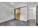 Bedroom with modern flooring, barn door to walk-in closet, and view of bathroom at 917 W Busby St, Lebanon, IN 46052