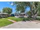 Charming single-story home with a covered porch, lush lawn, and mature trees creating a serene outdoor setting at 917 W Busby St, Lebanon, IN 46052