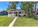 Charming home exterior with covered front porch, green lawn, and mature trees for curb appeal at 917 W Busby St, Lebanon, IN 46052