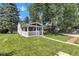 Home exterior with covered front porch, green lawn, and shade trees at 917 W Busby St, Lebanon, IN 46052