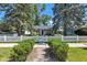 Charming home featuring a white picket fence, mature trees, and lush green bushes at 917 W Busby St, Lebanon, IN 46052