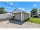 A detached garage with tan siding features a single-car garage door and attached driveway under a blue sky at 917 W Busby St, Lebanon, IN 46052