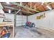 Inside the garage, the unfinished space is ready for projects, with exposed rafters and a white garage door at 917 W Busby St, Lebanon, IN 46052