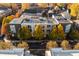An aerial view of a modern apartment complex surrounded by lush autumn foliage at 932 N Broadway St # 4, Indianapolis, IN 46202