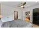 Comfortable bedroom with a ceiling fan, a large closet, and an adjacent room with a window and bright accents at 932 N Broadway St # 4, Indianapolis, IN 46202