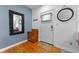 Welcoming entryway with hardwood floors, a decorative mirror, and a stylish cabinet offering functional storage space at 932 N Broadway St # 4, Indianapolis, IN 46202