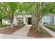 Inviting front exterior with well-maintained trees and a pathway to the entrance at 932 N Broadway St # 4, Indianapolis, IN 46202