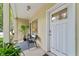 Charming front porch with a seating area, decorative plants, and a bright exterior door for a welcoming entrance at 932 N Broadway St # 4, Indianapolis, IN 46202