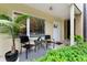 Inviting front porch features comfortable seating, a decorative rug, and lush greenery creating a cozy outdoor space at 932 N Broadway St # 4, Indianapolis, IN 46202