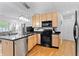 Well-appointed kitchen featuring stainless steel appliances, granite countertops, and stylish pendant lighting at 932 N Broadway St # 4, Indianapolis, IN 46202