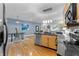 Charming kitchen that flows to the living space with stainless steel appliances, granite countertops, and hardwood floors at 932 N Broadway St # 4, Indianapolis, IN 46202