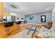 Open-concept living area featuring hardwood floors, modern lighting, and a stylish kitchen island with bar seating at 932 N Broadway St # 4, Indianapolis, IN 46202