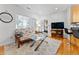 Bright living room with hardwood floors, a comfortable sofa, and great natural light streaming in through the windows at 932 N Broadway St # 4, Indianapolis, IN 46202