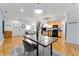 Open living space merges dining, kitchen, and living areas, featuring hardwood floors and lots of natural light at 932 N Broadway St # 4, Indianapolis, IN 46202