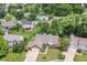 An aerial view of a brick home featuring a landscaped front yard and a neighborhood pool at 10306 Tybalt Dr, Fishers, IN 46038