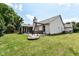 Exterior view of the house showcasing the backyard with a fire pit, swing set, and screened-in porch at 10306 Tybalt Dr, Fishers, IN 46038