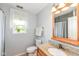 Bathroom featuring a granite vanity, toilet, tub and a bright window with natural lighting at 10306 Tybalt Dr, Fishers, IN 46038