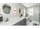 Modern bathroom with double vanities, stylish mirrors, and a bathtub at 10306 Tybalt Dr, Fishers, IN 46038