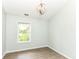 Bright bedroom with light-colored walls, wood-look floors, and a cozy window view at 10306 Tybalt Dr, Fishers, IN 46038