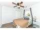 Inviting bedroom with a bed, ceiling fan, wood floors, closet, and a window providing natural light at 10306 Tybalt Dr, Fishers, IN 46038