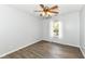 Cozy bedroom with wood flooring, a ceiling fan, and natural light from the window with sheer curtains at 10306 Tybalt Dr, Fishers, IN 46038