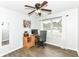 Functional bedroom with a ceiling fan, wood-look floors, and a desk at 10306 Tybalt Dr, Fishers, IN 46038