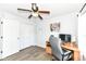 Bedroom featuring wood-look floors, a ceiling fan, and a closet at 10306 Tybalt Dr, Fishers, IN 46038