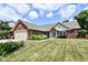 Beautiful brick home with a well-manicured lawn and garden at 10306 Tybalt Dr, Fishers, IN 46038