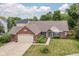 Charming single-story brick home with manicured lawn and lush landscaping at 10306 Tybalt Dr, Fishers, IN 46038
