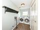 Functional laundry room with a washer, dryer, and storage shelves at 10306 Tybalt Dr, Fishers, IN 46038