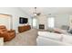 Bright living room featuring plush seating, a fireplace, and a modern entertainment center at 10306 Tybalt Dr, Fishers, IN 46038