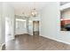 Inviting living room with high ceilings, wood floors, and a modern light fixture at 10306 Tybalt Dr, Fishers, IN 46038